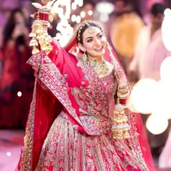 The pure joy of a bride's entrance. I captured this bride's radiant smile as she walks in, holding a sparkler, a moment filled with happiness and celebration. This candid shot perfectly encapsulates the excitement of the wedding day.