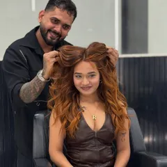A happy client showing off her new copper glow. The color adds so much warmth and personality to her look, and the voluminous styling is the perfect finish.