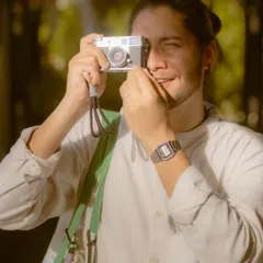 Here I am testing out a vintage-style Fujifilm camera. This photo emphasizes the hands-on, creative process, connecting the brand with the passion of photography itself.
