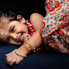 A cheerful and fun Diwali portrait. Dressed in her festive Indian attire, this little girl's bright smile perfectly captures the spirit of the festival of lights.