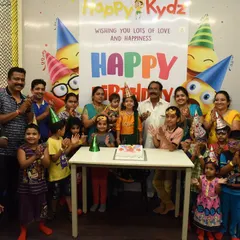 From small family gatherings to big birthday bashes with all their friends, we can host it all. This photo captures a wonderful celebration with the whole family joining in on the fun in our dedicated kids' party venue.