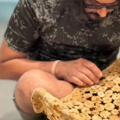 Here I am in the studio, making final touches to a piece. This image captures the hands-on, personal nature of my work, where every detail is carefully considered and crafted by hand.