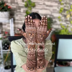 A full-arm design featuring symmetrical peacocks on the palms and a band of elephants on the forearms. This style is a classic choice for festivals and weddings.