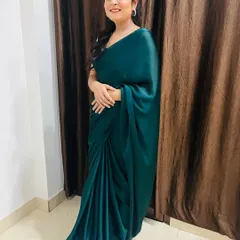A full-length view showing how the simple, elegant hairstyle complements the satin saree. This is a perfect example of a timeless party look.