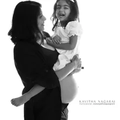 The joy of pregnancy is multiplied when shared with your loved ones. This black and white portrait of a mother and daughter laughing together is full of pure happiness.