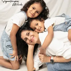 A pile of love! This candid shot of a mother and her two daughters is full of laughter and affection, showcasing the fun and playful side of family portraits.