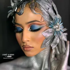 A full view of a fantasy look created by our students. The artistry extends from the face to the body, incorporating silver body paint and sculpted hair to create a cohesive, otherworldly character.