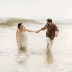 The pure joy of a couple running through the waves. We encourage playful, unscripted moments during our pre-wedding beach shoots to capture authentic laughter and connection.
