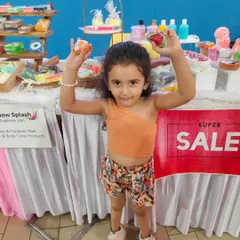 A happy little customer holding up her favorite fruit-shaped soaps at my exhibition stall. Seeing smiles like this is the best part of my job.