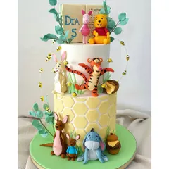 A full view of the Winnie the Pooh cake, showing how all the characters from the Hundred Acre Wood came together for the celebration.