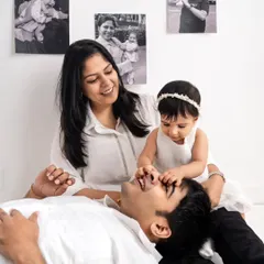 A playful and loving moment between parents and their baby during our unique "Memory Lane" photoshoot.