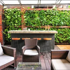 For this residential villa, we designed a semi-open bar and lounge area that seamlessly integrates with nature. We installed a wood-framed living wall with over 700 plants, creating a lush, green backdrop that maximizes vertical space and provides a stunning focal point for entertaining.