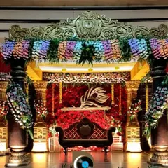For a traditional wedding, we designed this opulent stage with intricate golden pillars, a rich red backdrop, and dense floral arrangements for a truly royal feel.