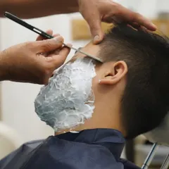I use a traditional straight razor for the ultimate in precision and closeness. This technique, performed by my skilled hands, provides a superior, long-lasting finish that modern razors can't match.