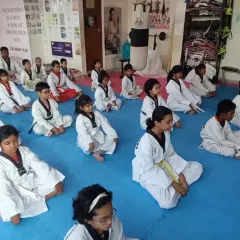 A moment of quiet concentration for the entire class. Mental discipline is a core pillar of Taekwondo.