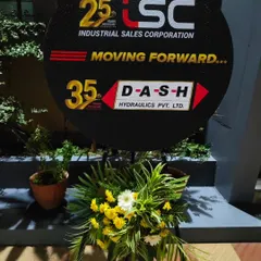 A custom branded sign I created for the Industrial Sales Corporation's 25th anniversary. The sign is complemented by a fresh floral arrangement at its base.
