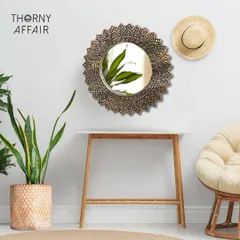 This is one of my favorite pieces, a sunburst-style mirror that brings so much warmth and texture to a room. Styled here in a cozy corner, it shows how a single piece of wall art can define the mood, blending beautifully with natural elements like plants and rattan.