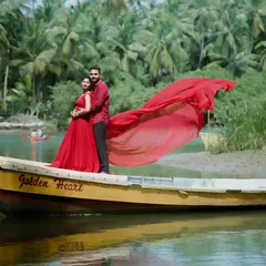 For this pre-wedding shoot, we used the beautiful Karavali coastline. The flowing red gown against the serene backwaters and the 'Golden Heart' boat created a truly cinematic and romantic photograph.