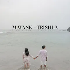 A powerful and serene image of the couple holding hands as they stand in the ocean, looking out at the horizon. This pre-wedding photo symbolizes them stepping into their future together.