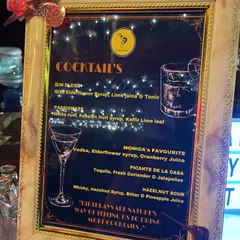 An elegant, framed cocktail menu designed for a birthday party. We can create custom names for drinks, like 'Monica's Favourite', to add a special, personal touch for the guest of honor.