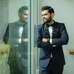 A dapper groom ready for his engagement night. This portrait captures his confident smile and sharp style, with his reflection adding a cool, modern touch.