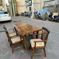 The dining set is shown with four chairs, perfect for a small restaurant or a private dining room.
