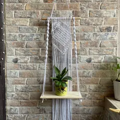 A closer look at a single-shelf design in classic white. The top section features a detailed flat-panel knot pattern, while the simple hanging cords keep the focus on what you choose to display. It’s ideal for a narrow wall or balcony.