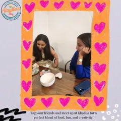 A snapshot of two friends deep in their creative process, framed by a heart. It's a place to spend quality time with loved ones.