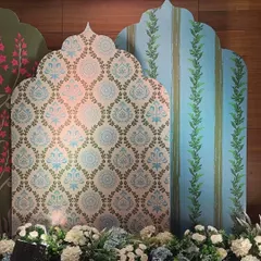 A sophisticated backdrop for a 'Sehrabandi' ceremony, featuring arched panels with custom-printed damask and botanical patterns in a serene palette of powder blue and green.
