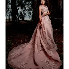 This light pink floral appliqué gown is a fairytale moment waiting to happen. Its magnificent train creates breathtaking photos, making it a perfect choice for a pre-wedding shoot or a grand reception entrance.