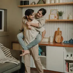 A fun piggyback ride in the kitchen. These candid, happy moments are what make an at-home pre-wedding shoot feel so genuine and personal.