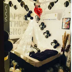 I offer a variety of decoration themes, like this stylish black, white, and red setup. It includes a fairy-lit cabana, balloons covering the ceiling, and personalized "Happy Birthday" messages to make the celebration uniquely yours.