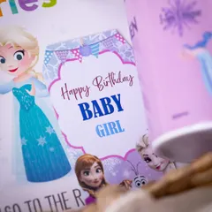 A custom 'Happy Birthday Baby Girl' tag with characters from 'Frozen', showing how I carry a theme through every detail of the hamper.