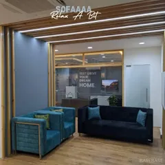 A comfortable lounge area we created for an office space. The plush blue sofas and armchairs offer a place for employees to relax, collaborate, or "test drive their dream home."