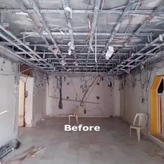 The 'Before' shot of the multi-purpose living room, showing exposed ceiling framework and bare walls. This raw space was a blank slate for us to create a completely new environment tailored to the client's hobbies and lifestyle.