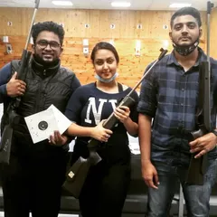 This group of three just finished their session, with one guest proudly showing off her impressive target sheet. It's that moment of hitting the mark that gets people hooked.