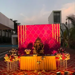 Another angle of the vibrant Ganpati welcome decor, showing the full outdoor setting against a modern building. The colorful carpet and lighting create a festive atmosphere for evening celebrations.