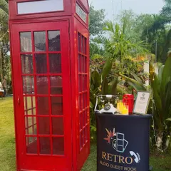 My classic red British-style phone booth is always a hit. This complete setup includes the iconic booth, a separate podium, and a vintage phone, creating a fun, nostalgic experience for your guests at any wedding or party.