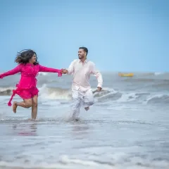 Running together on the beach, hand in hand. This is a classic pre-wedding shot that feels energetic, romantic, and full of life.