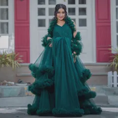 A full-length shot of our dramatic emerald green tulle gown with ruffled details. This rental is perfect for making a grand entrance.