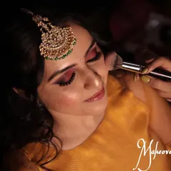 The process of creating a flawless base. Here, I am applying blush to add a natural flush of color to the cheeks for Chinmayi's mehendi look.