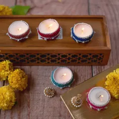 Our small crochet diya jackets are perfect for scattering light around your home. Available in a range of colors like red, blue, green, and pink, they fit standard tea lights and can be reused year after year.