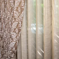 We bring timeless elegance to your windows by layering different textures. Here, a luxurious velvet blend drape with nature-inspired leaf motifs is paired with a lightweight sheer, allowing natural light to filter through while maintaining privacy in this DLF Phase 2 home.
