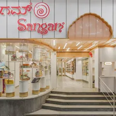 The storefront of Sangam Sweets in Kalyan Nagar, designed to reflect a craft handed down through generations. The design blends traditional motifs with contemporary flavors, creating an inviting space for a modern Indian palate.