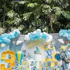 A sweet and gentle baby elephant theme for a sunny outdoor celebration. I used a soft pastel color palette of blue, yellow, and white, with cute elephant cutouts and a hot air balloon prop to create an adorable setting for a third birthday party.