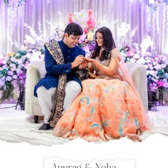 A beautiful moment as the groom slips the ring onto the bride's finger during their lavishly decorated engagement ceremony.