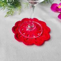 This vibrant red mandala coaster is designed to perfectly cradle the base of a wine glass. It's a simple way to add a touch of elegance and protect your furniture during a relaxing evening.