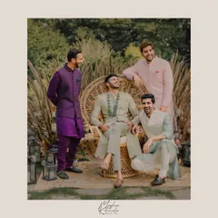 Dapper groomsmen styled for a daytime wedding event. We selected outfits in a range of complementary colors like sage green, purple, and pink, creating a look that is coordinated yet allows for individual personality.
