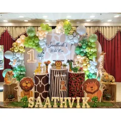 For this "Wild One" first birthday, I transformed the space into a vibrant jungle. The setup includes custom animal print pedestals, character cutouts of lions and zebras, and a lush balloon arch to create a fun safari adventure.