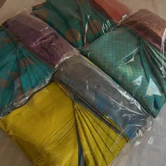 A collection of beautiful silk sarees, all neatly box-folded and packed for a customer. This method keeps them compact, organized, and completely free of creases in the wardrobe.